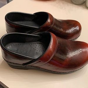 Brown patent leather Sanita slip ons.